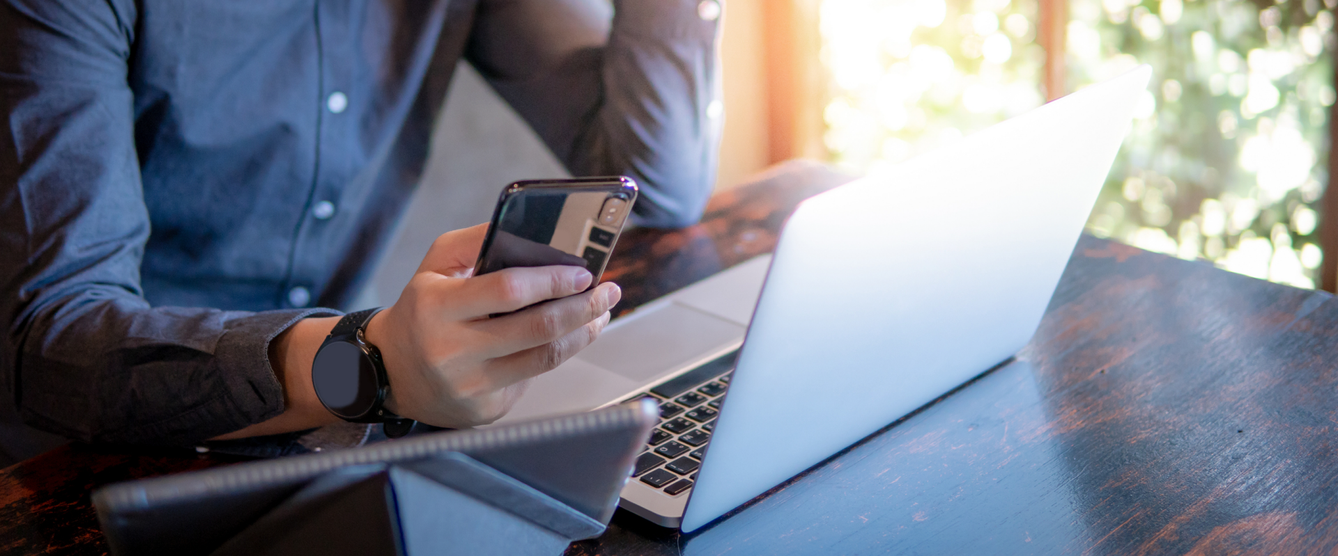 man searching on phone and computer