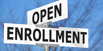 A street sign reading open enrollment. 