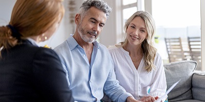 Man and woman in meeting looking at paper