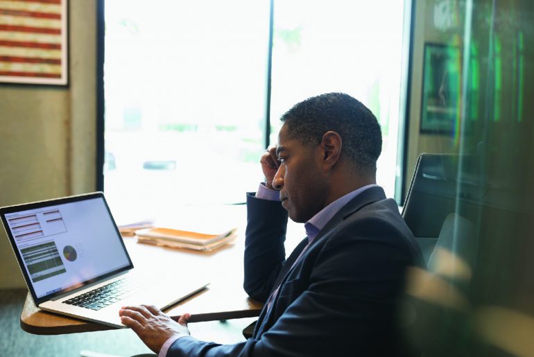  Financial professional writing a blog post on laptop