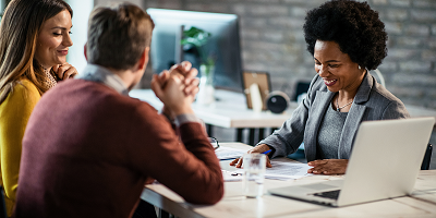 Couple meeting with female financial professional at desk