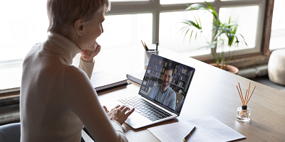 Female client using laptop to video conference with advisor