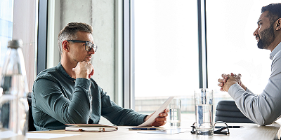 Man sitting at table across from financial representative 