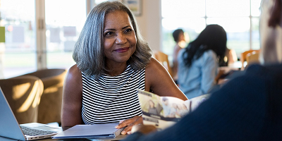 A single female client sitting with her financial representative following her husband’s death. 