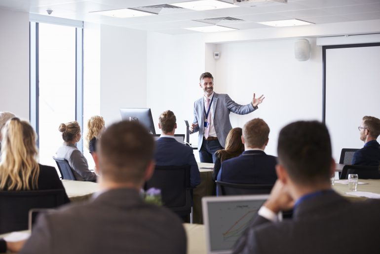 Business executive giving a talk to colleagues. 