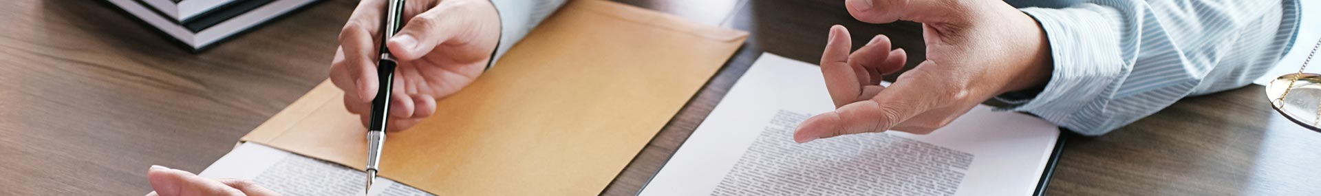 Financial advisor speaks with his mature clients while reviewing their retirement documents. 